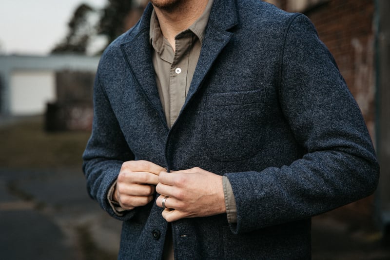 author buttoning up Buck Mason wool chore coat