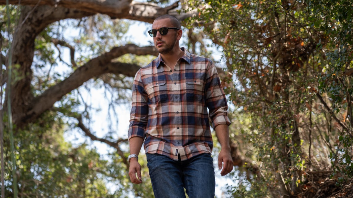 Flag and Anthem Review Model Wearing FLag and Anthem Flannel and Jeans Outdoors