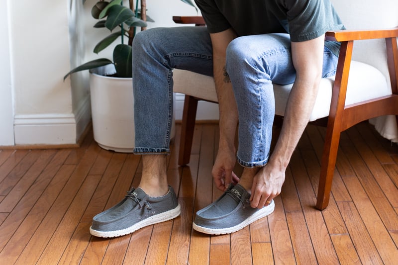 HEYDUDE Shoes Wally Stretch being put on while sitting