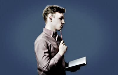 2020/10/How-to-Get-Your-Life-Together-Man-Holding-Pencil-and-Book-on-Blue-Background.jpg