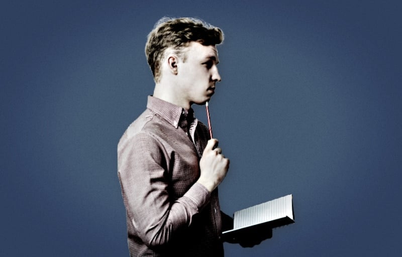 How to Get Your Life Together Man Holding Pencil and Book on Blue Background