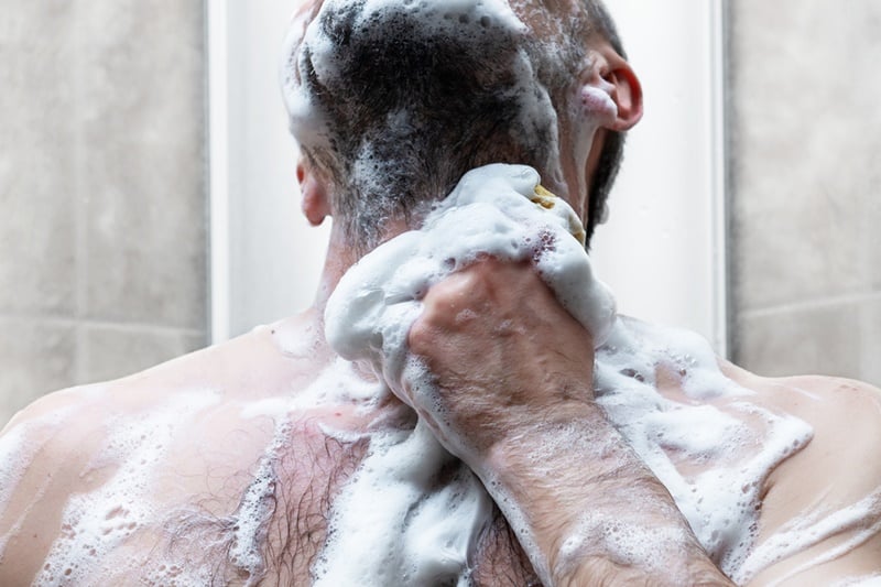 man takes shower modern tiled