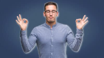 2021/04/Meditation-for-Men_-Man-in-Blue-Shirt-Meditating-and-Holding-Hands-Up.jpg
