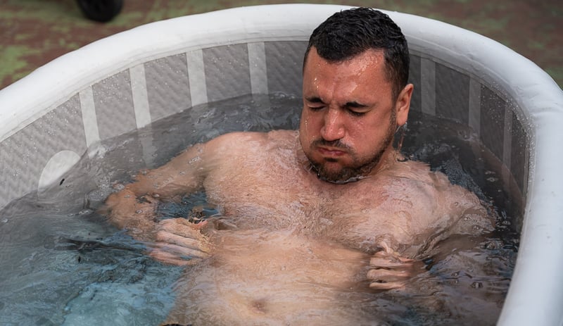 Model dips in Redwood Outdoors Yukon Cold Plunge