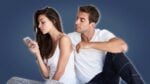 Signs She Is Pretending to Love You Girl on Phone guy looking over her shoulder in pajamas