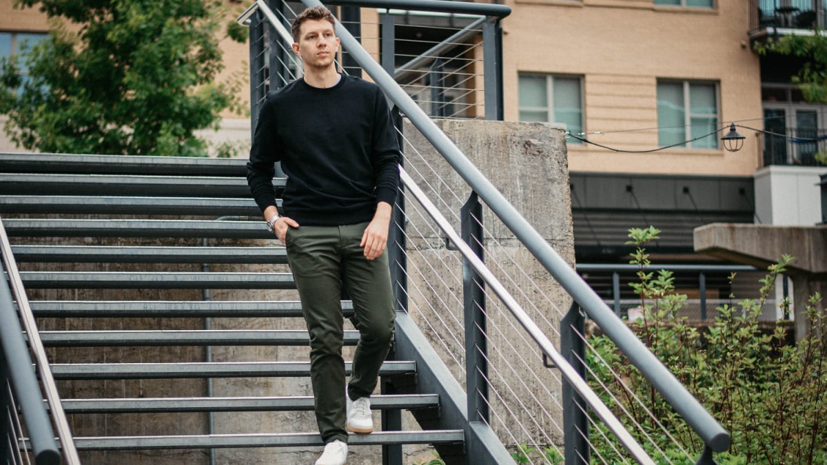 What goes with green pants Man wearing green chinos with white sneakers and black crew sweatshirt